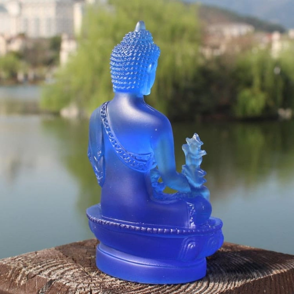 Dos de la statuette de Bouddha bleue avec drapé et socle lotus