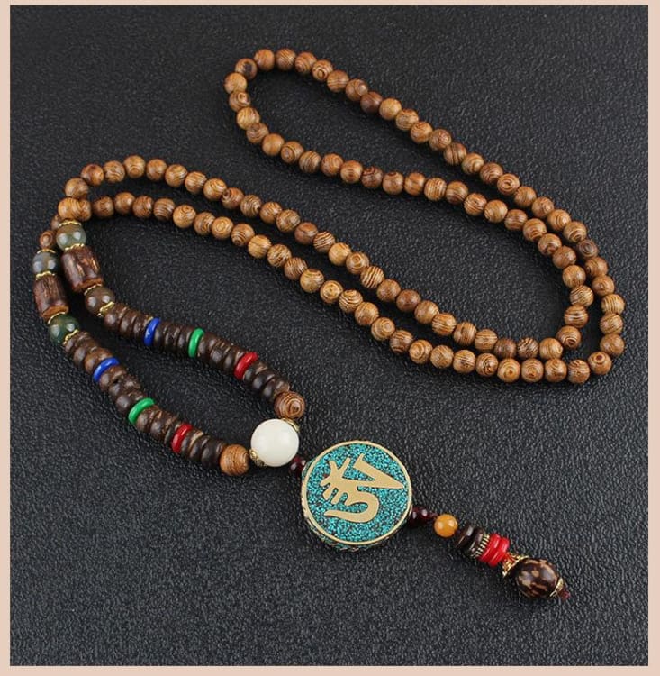 Pendentif tibétain symbole bouddhiste Om Pendentif tibétain symbole bouddhiste Om